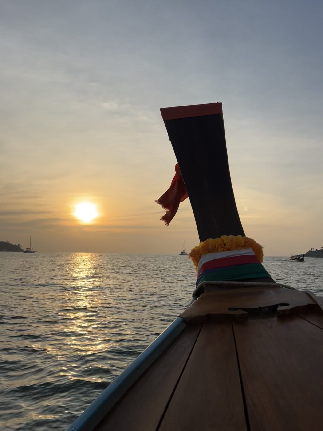 Golden sunset over the sea from a private longtail boat